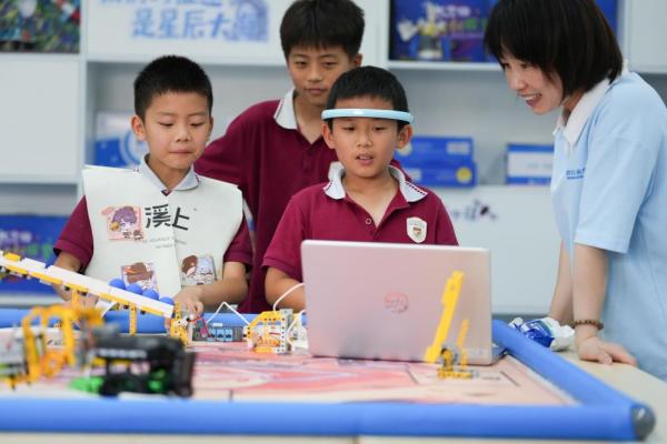 2025年5月30日,在长沙市天心区仰天湖实验学校,学生在科技节上体验“脑机星球”。新华社记者 陈泽国 摄
